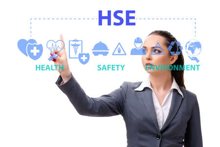 HSE concept with businesswoman pressing virtual buttonの写真素材