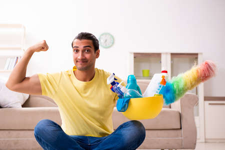 Young male contractor doing housework at home