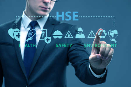 HSE concept with the businessman pressing virtual buttonの写真素材