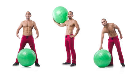 Man with swiss ball doing exercises on whiteの写真素材