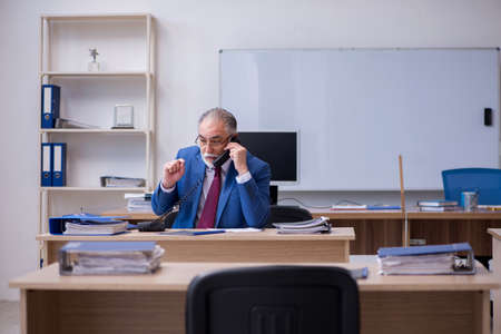 Old male boss employee working in the officeの写真素材