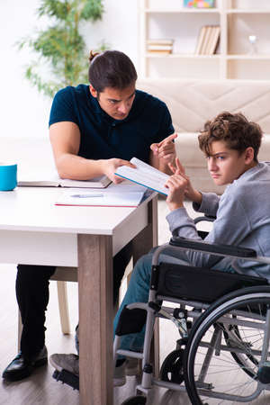 Father and disabled son in education conceptの写真素材
