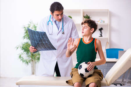 Sick boy visiting young male doctor pediatricianの写真素材