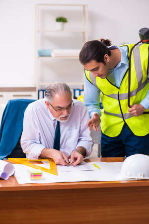 Two male architects working in the officeの写真素材