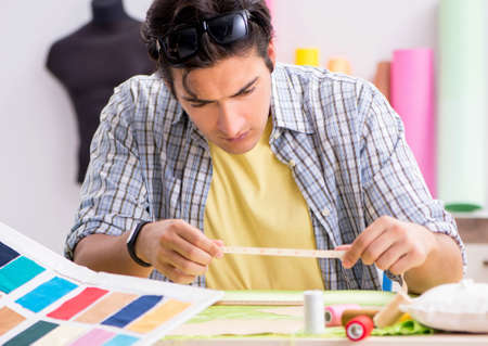 Young tailor working in his workshop