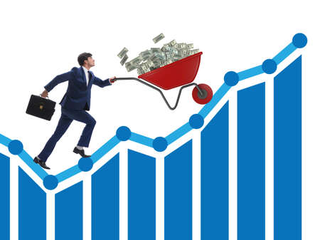 Businessman pushing wheelbarrow full of dollar moneyの写真素材