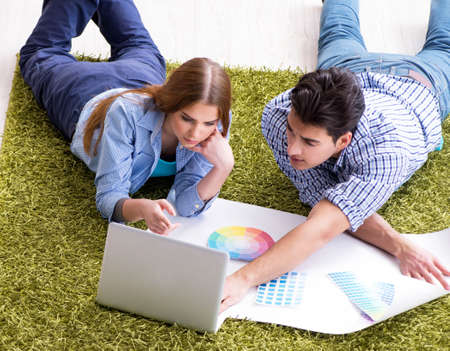 Young family planning home DIY renovation with drawingの写真素材