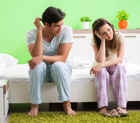 Woman and man in the bedroom after conflictの写真素材
