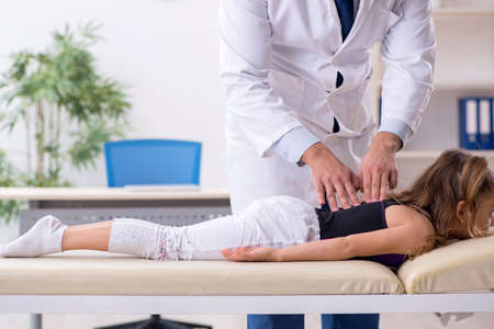 Small girl visiting young male doctorの写真素材