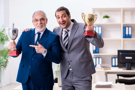 Two male employees working in the officeの写真素材