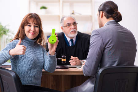 Young woman in courthouse with judge and lawyer