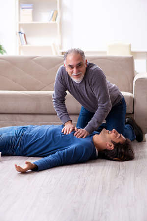 Grandfather and grandson in first aid concept