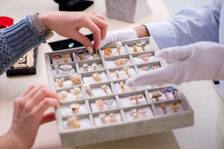 Male jeweler and female client at store