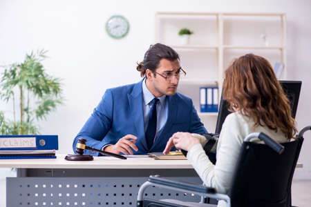 Injured woman and male judge in the courtroomの写真素材