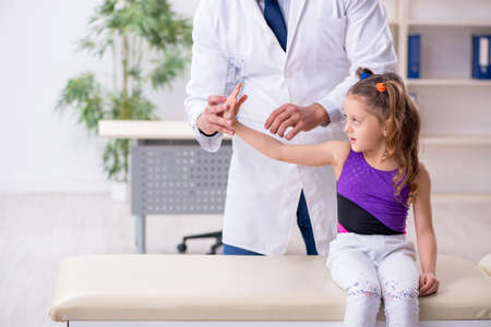 Small girl visiting young male doctorの写真素材