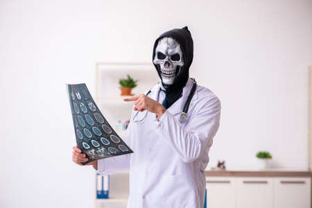 Male devil doctor radiologist working in clinicの写真素材