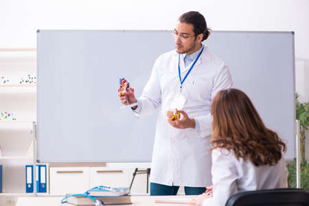 Young male doctor cardiologist and female student in the classroの写真素材