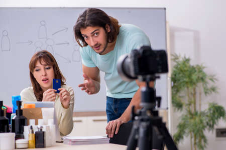 Young couple sales consultants recording video for their blog