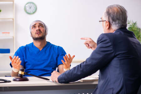 Male doctor in courthouse meeting with advocateの写真素材