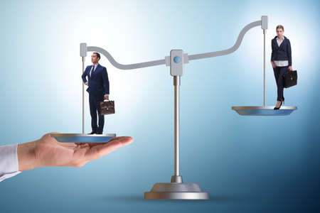 Work inequality concept with man and woman on scalesの写真素材