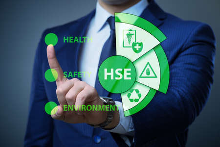 HSE concept with businessman pressing virtual buttonの写真素材