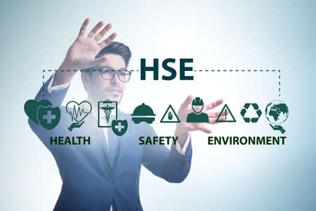 HSE concept with businessman pressing virtual buttonの写真素材