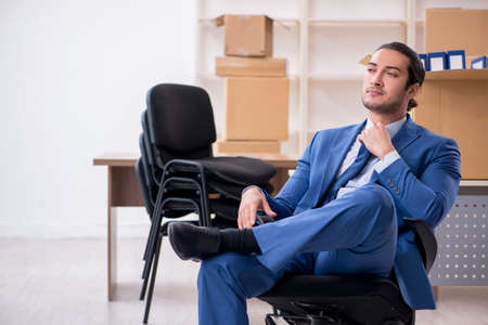 Young male employee in relocation conceptの写真素材