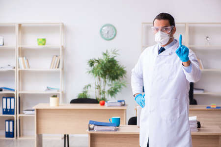 Young male doctor virologist in the officeの写真素材