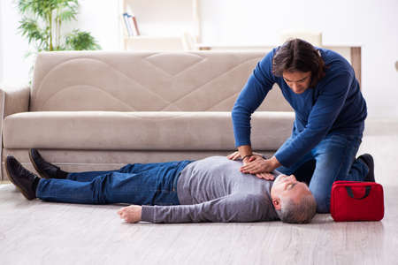 Grandfather and grandson in first aid conceptの写真素材