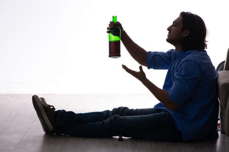 Young man suffering from alcoholismの写真素材