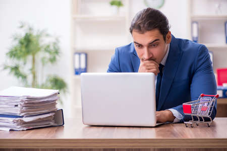 Young male businessman in ecommerce conceptの写真素材