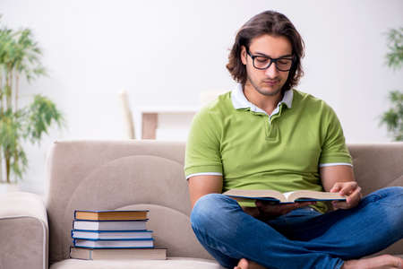 Young male student preparing for exams at homeの写真素材
