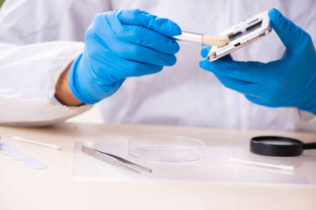 Male expert criminologist working in the lab for evidenceの写真素材