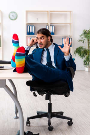 Young male businessman working in the officeの写真素材