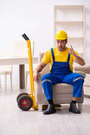 Young male contractor in relocation conceptの写真素材