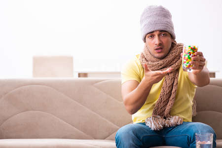 Young man suffering at homeの写真素材