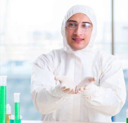 Young chemist student working in lab on chemicalsの写真素材