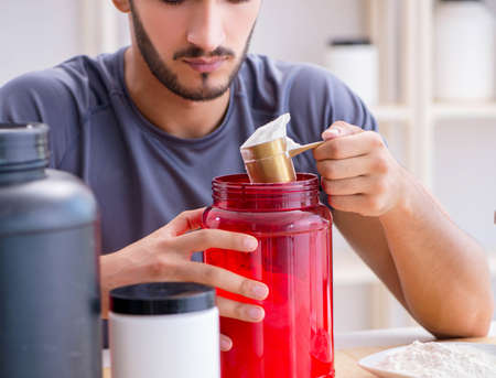 Athlete tasting new protein supplements for better musclesの写真素材