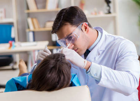 Patient visiting dentist for regular check-up and fillingの写真素材