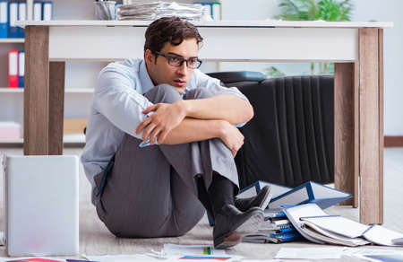 Bankrupt businessman angry in the office floorの写真素材