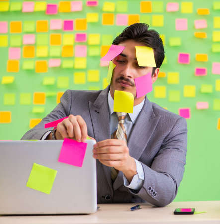 Businessman with many conflicting prioritiesの写真素材