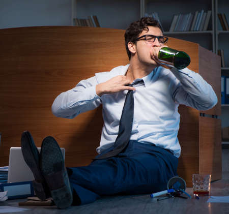 Stressed businessman working overtime in depression
