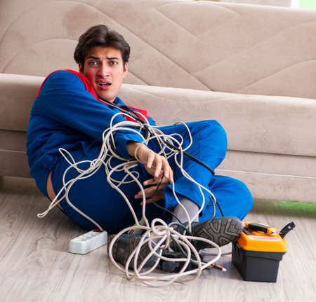 Electrician contractor with tangled cablesの写真素材