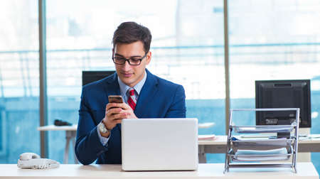 Businessman employee talking on the office phone