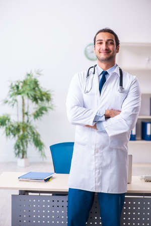 Young male handsome doctor working in the clinicの写真素材