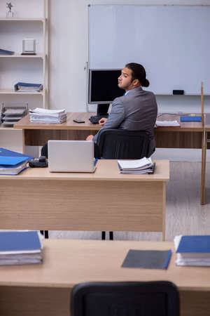 Young male businessman employee working in the officeの写真素材