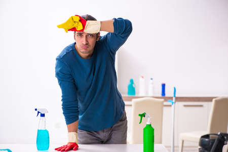 Young man husband doing housework at home