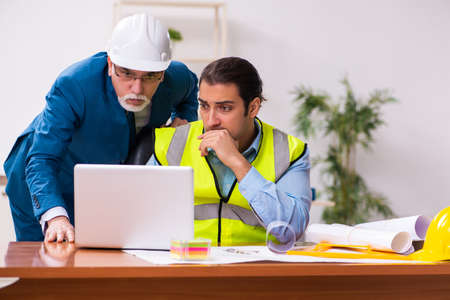 Two male architects working in the officeの写真素材