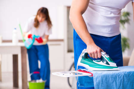 Young pair doing clothing ironing at the homeの写真素材