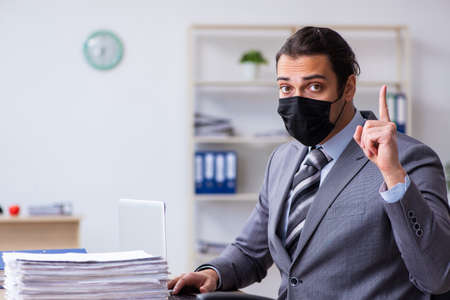 Young male employee in self-quarantine conceptの写真素材